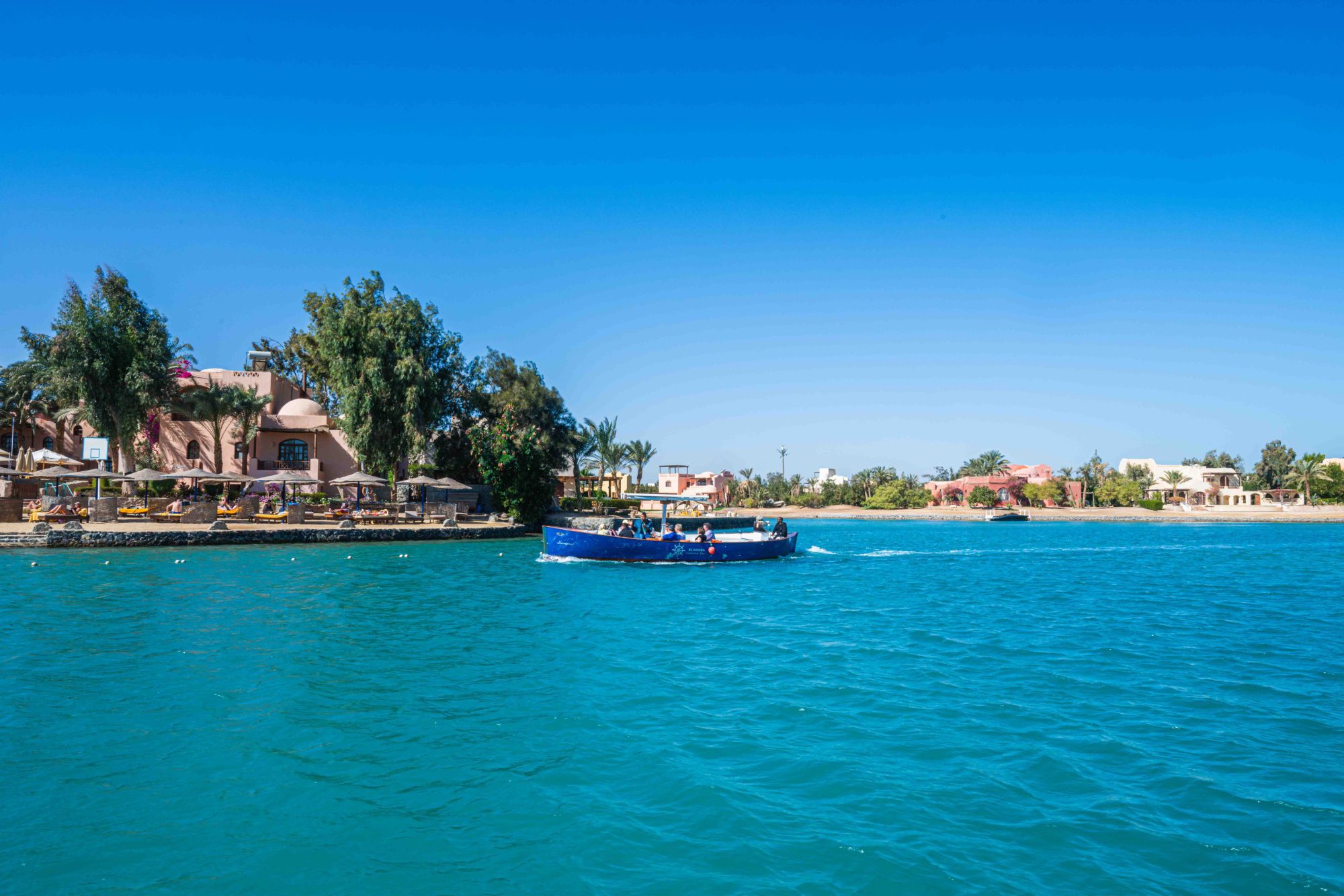 a boat trip - one of the most relaxing things to do in el Gouna) sails through the harbour in el Gouna carrying tourists,
